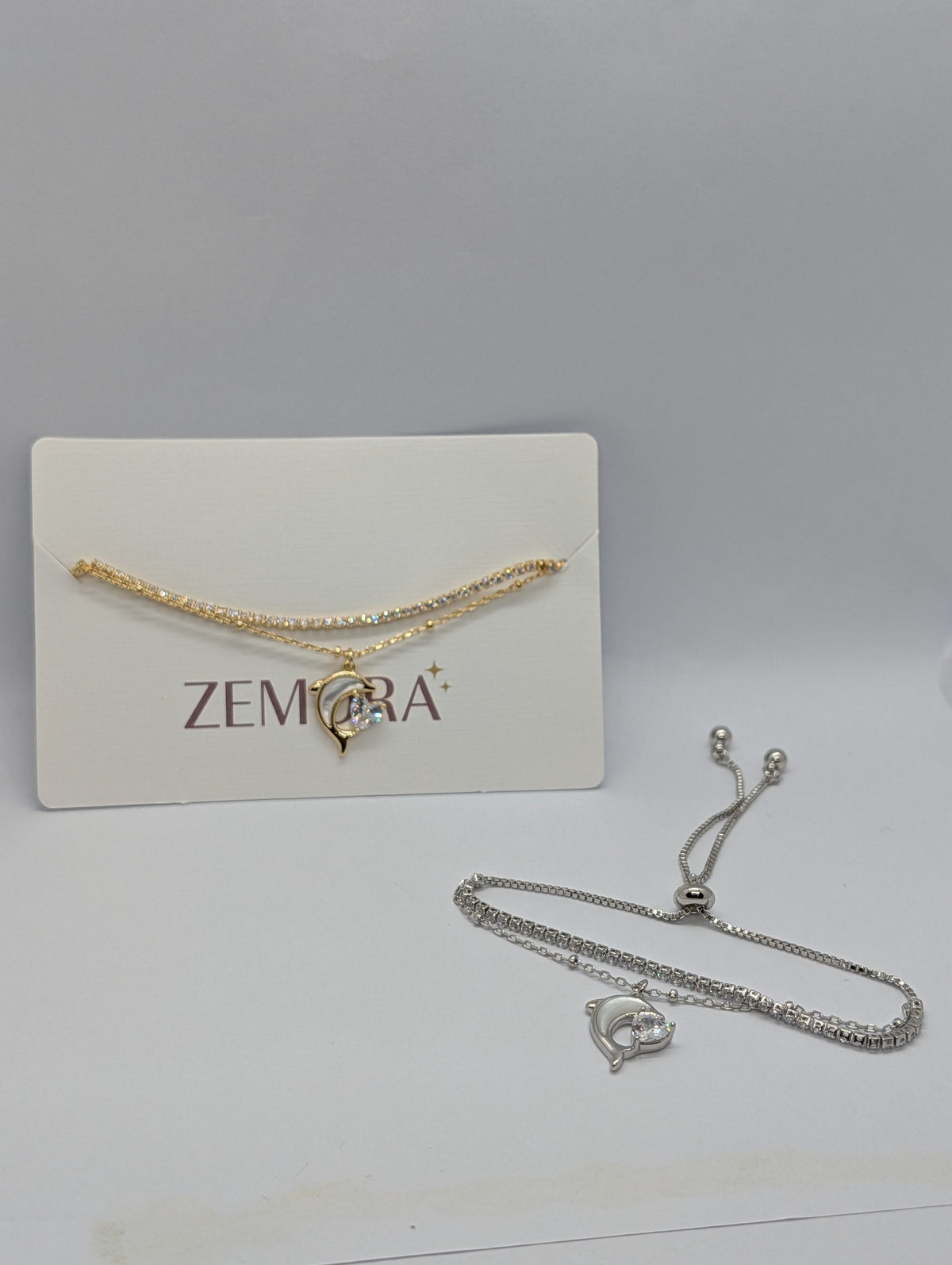 CZ Dolphin Charm Double Layer Bracelet - Gold and Silver tone both versions on Zemora card display