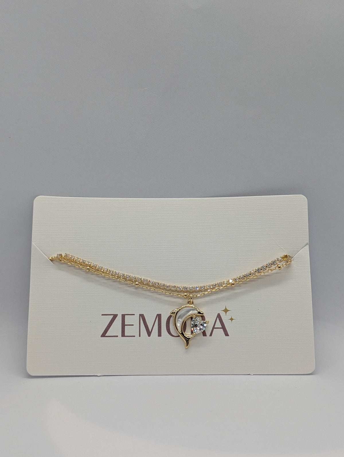 CZ Dolphin Charm Double Layer Bracelet - Gold tone on Zemora card display