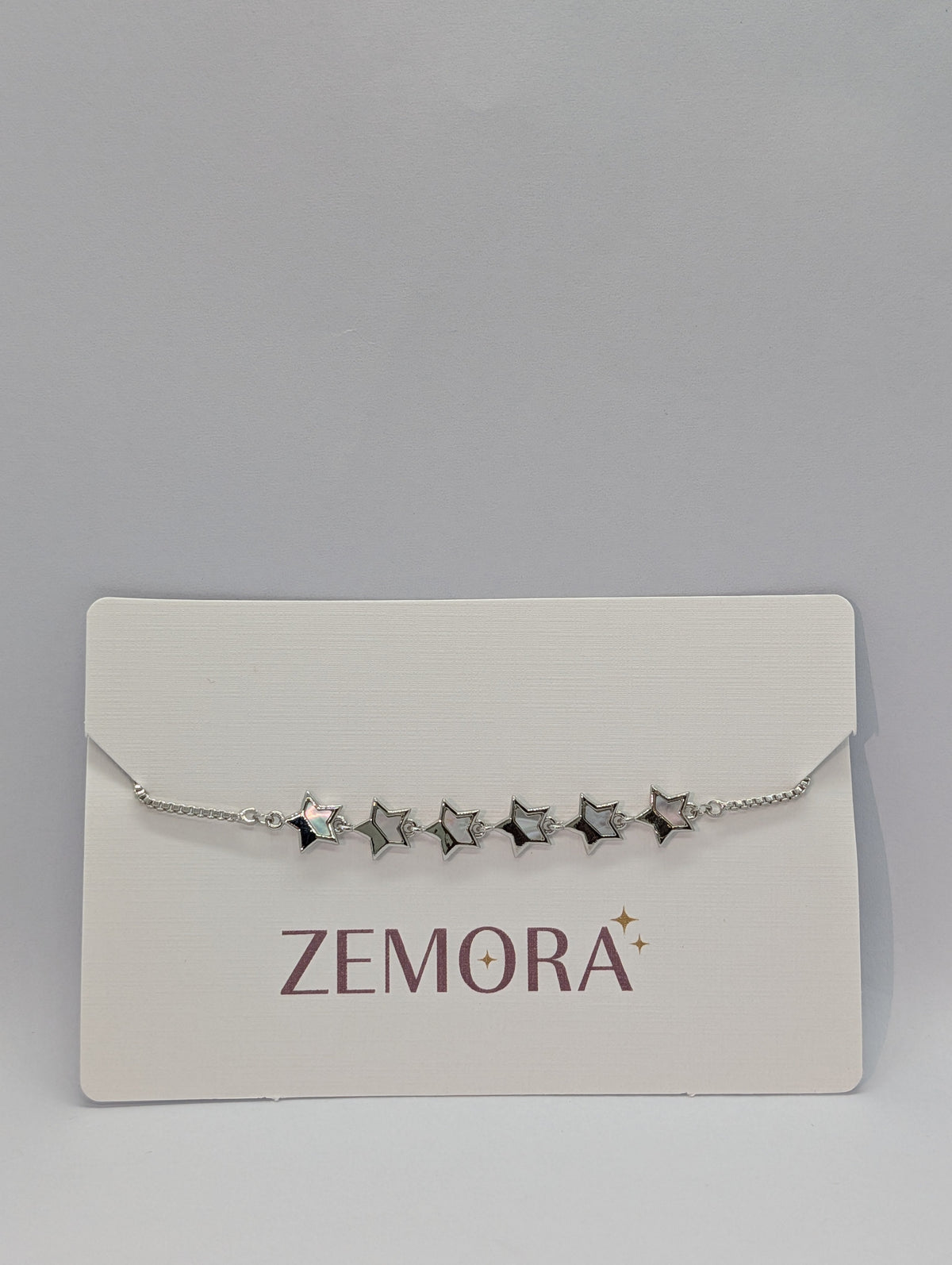 Mother of Pearl Open Star Station Bracelet - Silver tone open stars on Zemora card display