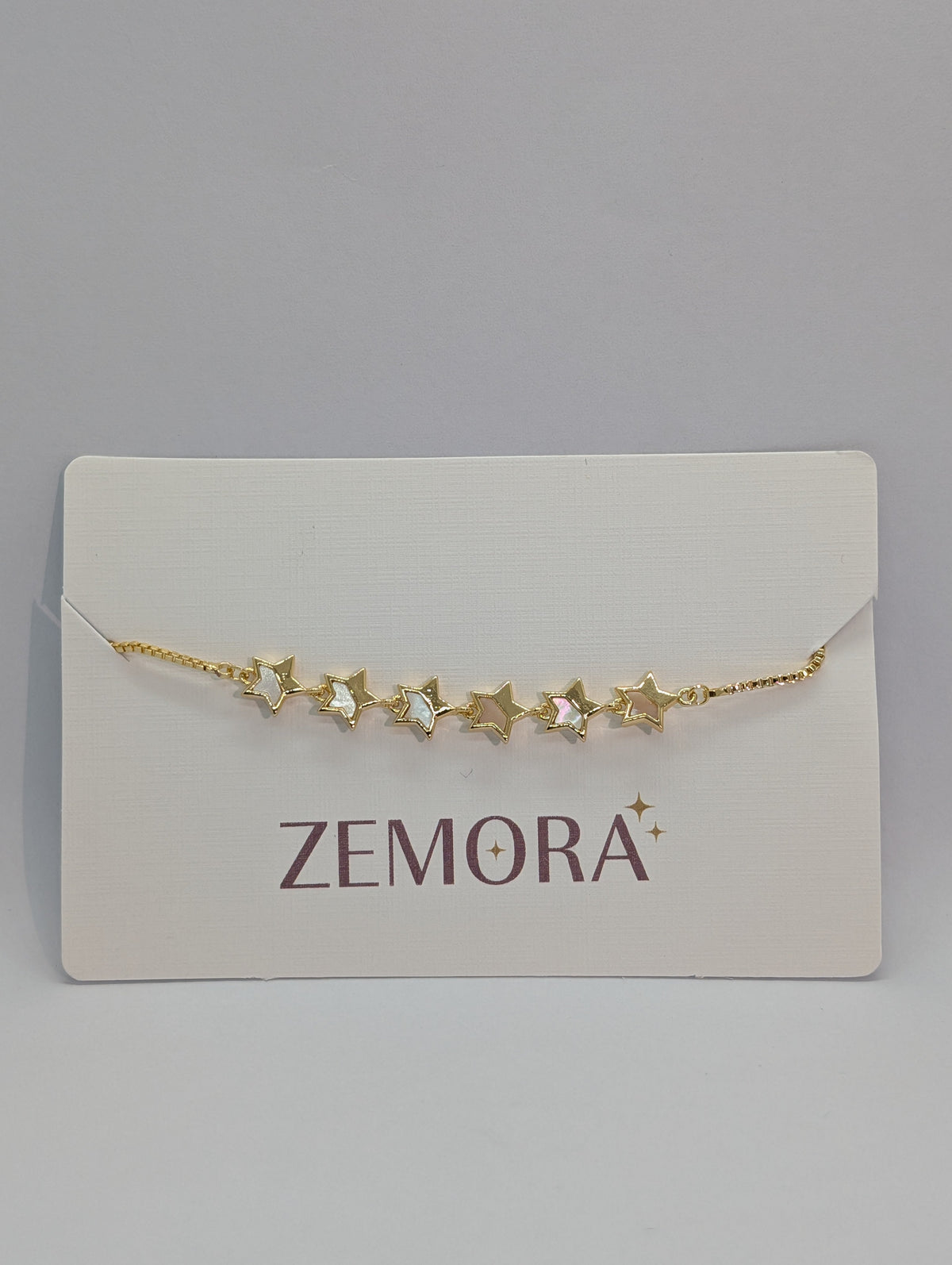Mother of Pearl Open Star Station Bracelet - Gold tone close up on Zemora card display