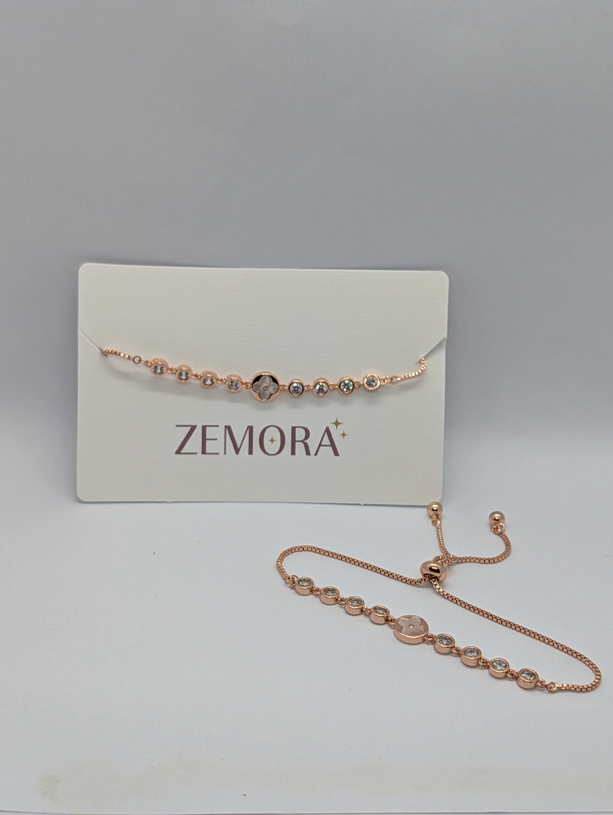 Rose gold CZ bezel clover charm station adjustable bracelet on Zemora jewellery card
