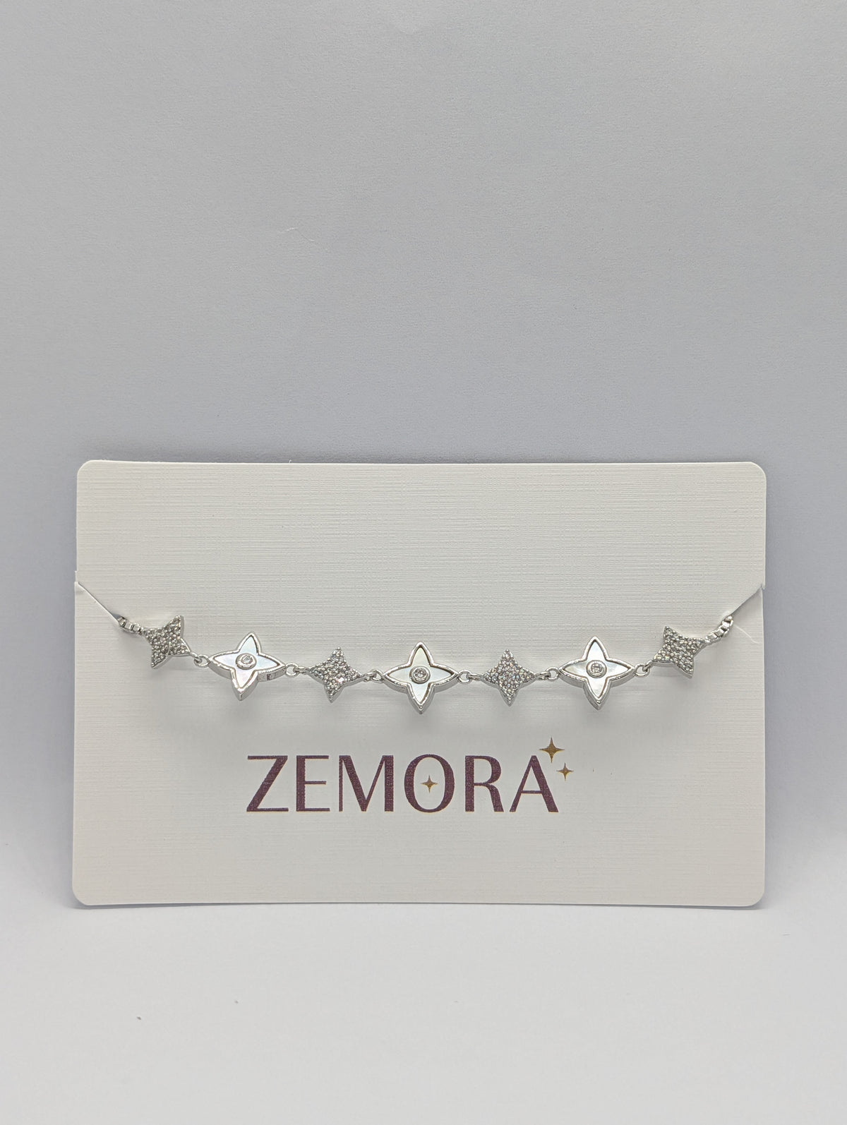 Silver CZ pavé star charm station adjustable bracelet on Zemora jewellery card