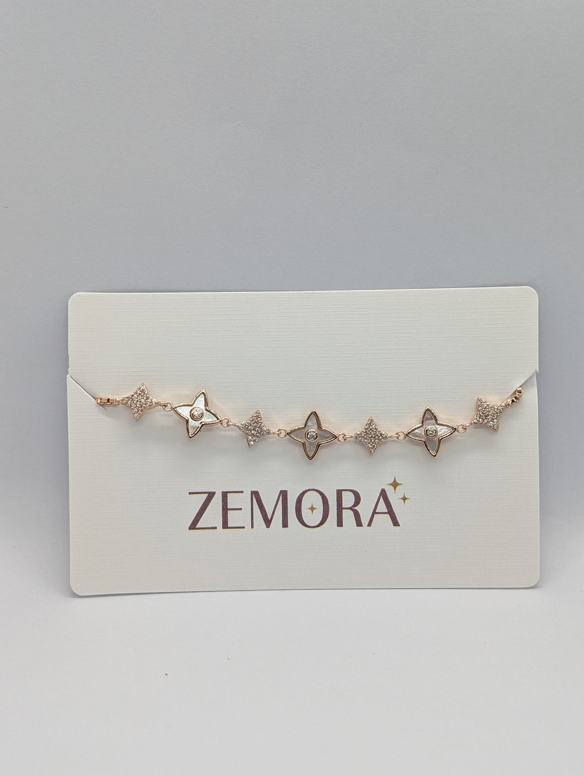 Rose gold CZ pavé star charm station adjustable bracelet on Zemora jewellery card