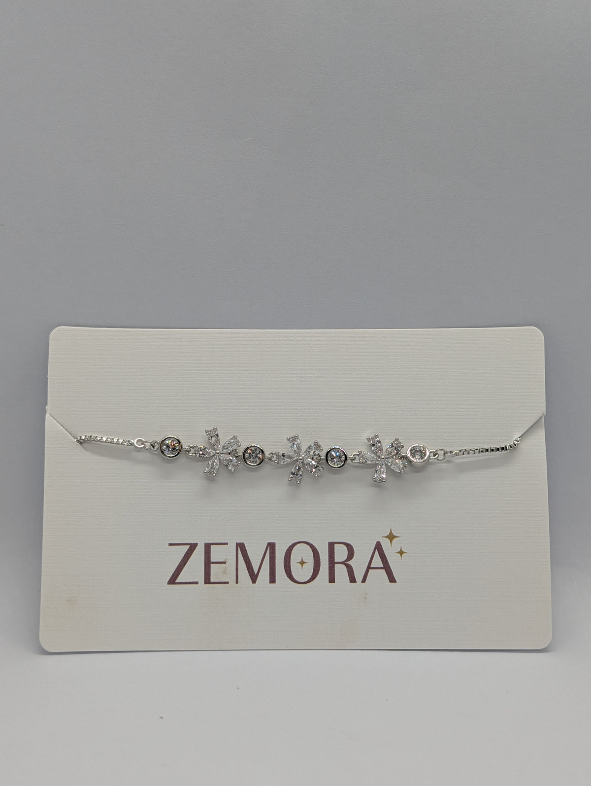 Rose gold CZ marquise flower bezel station bracelet on Zemora jewellery card