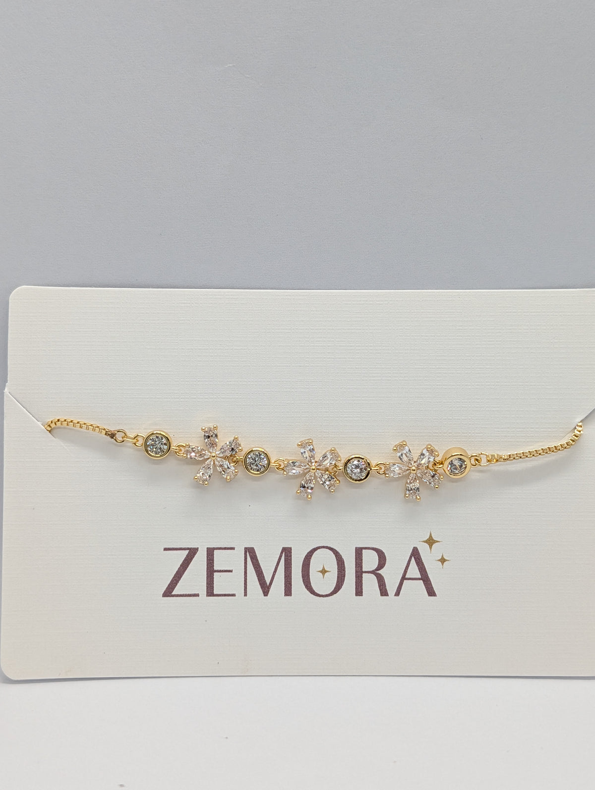 Yellow gold CZ marquise flower bezel station adjustable bracelet on Zemora jewellery card