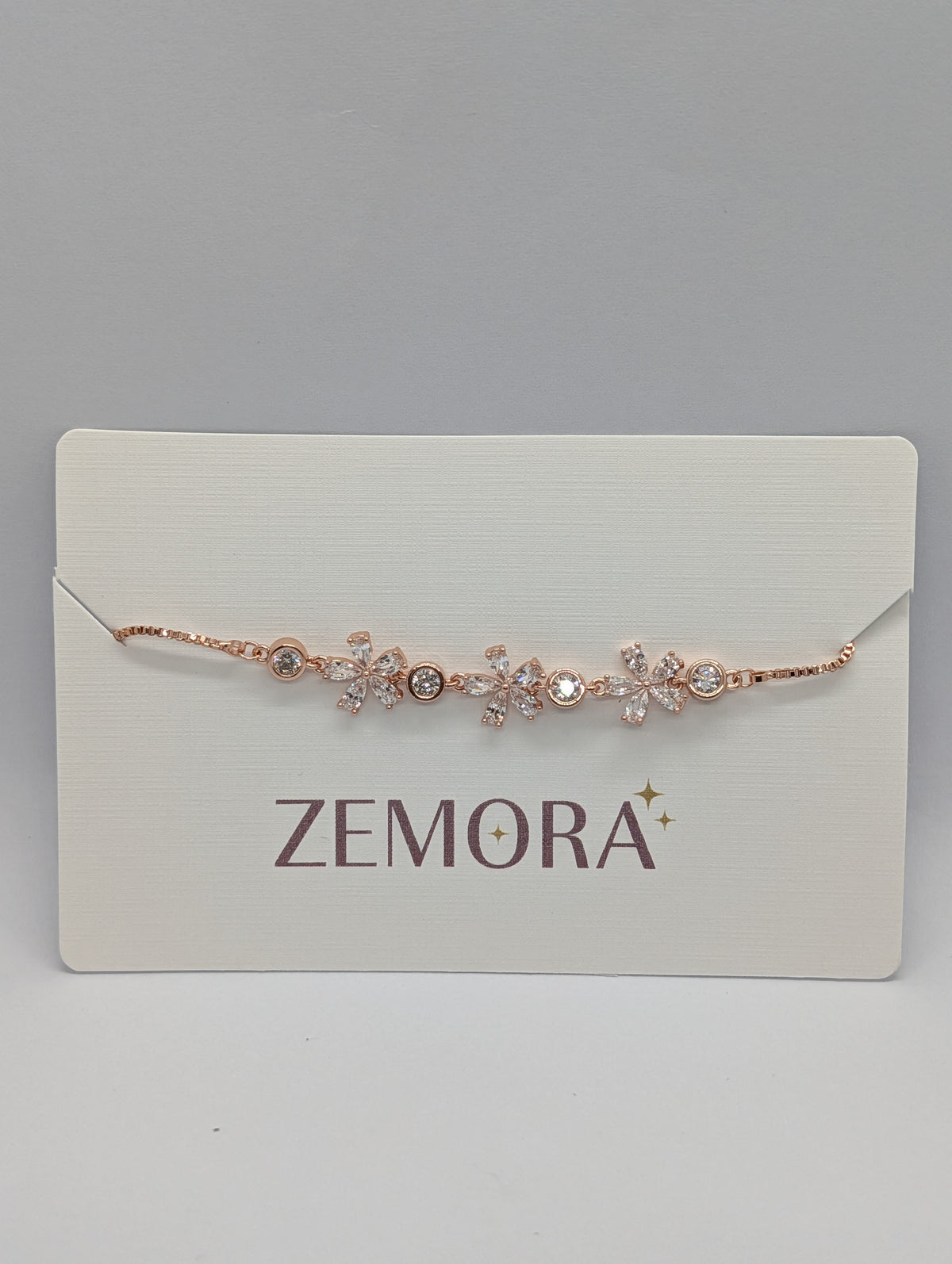 Silver CZ marquise flower bezel station bracelet close-up on Zemora card