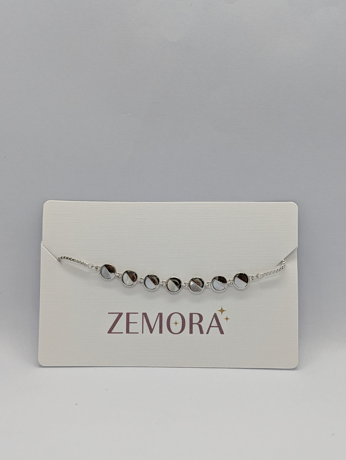 Rose gold mirror disc station bracelet flat lay showing bolo adjustable slider