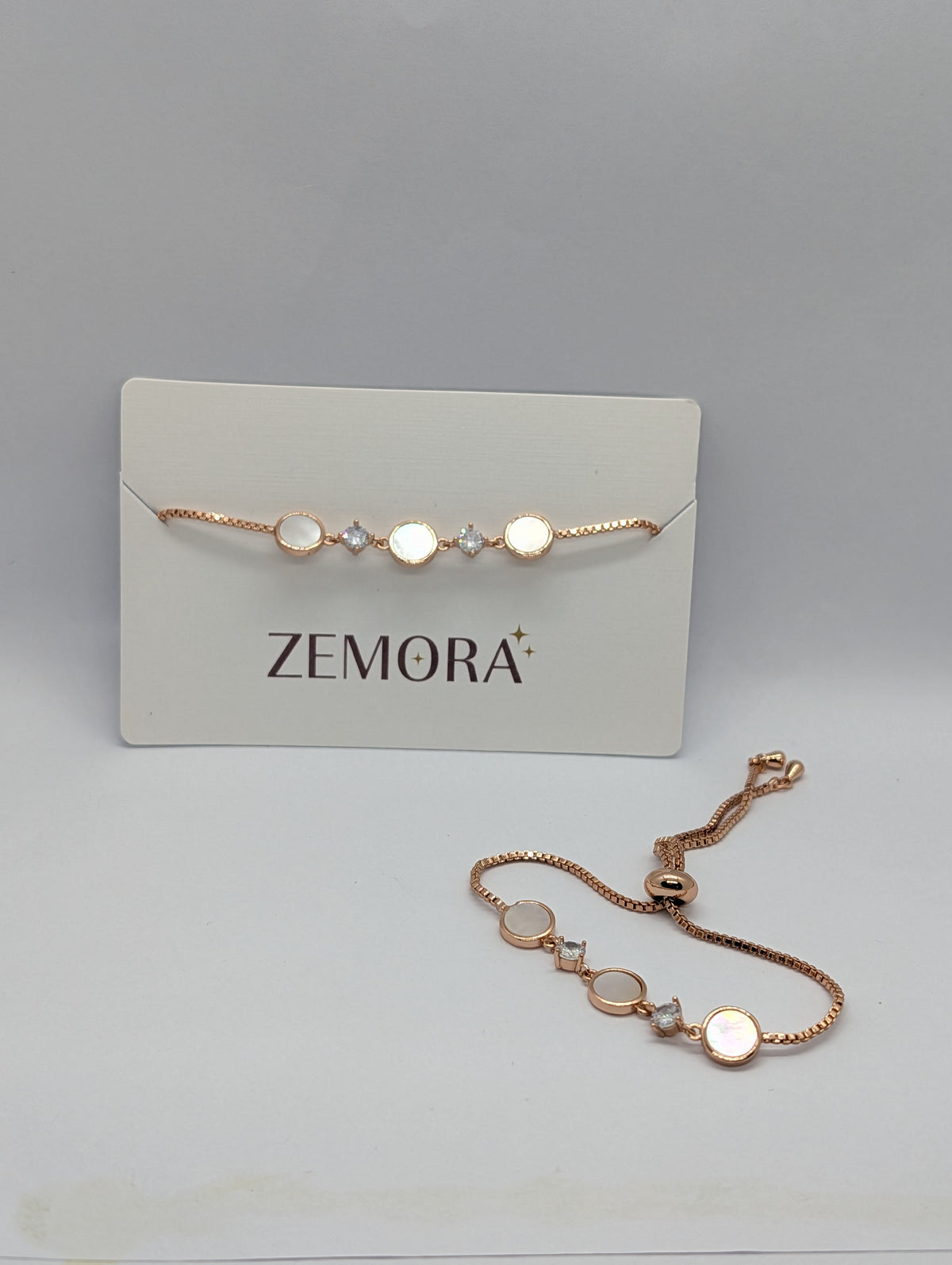Yellow gold luminous shell disc solitaire charm bracelet on Zemora jewellery card