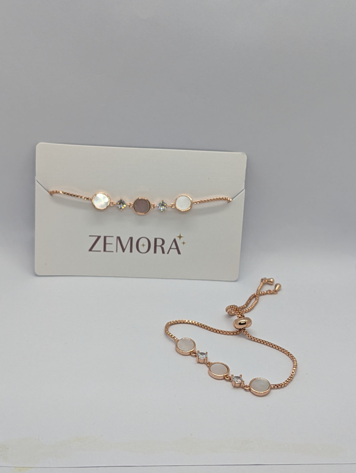 Rose gold luminous shell disc solitaire charm bracelet on Zemora jewellery card