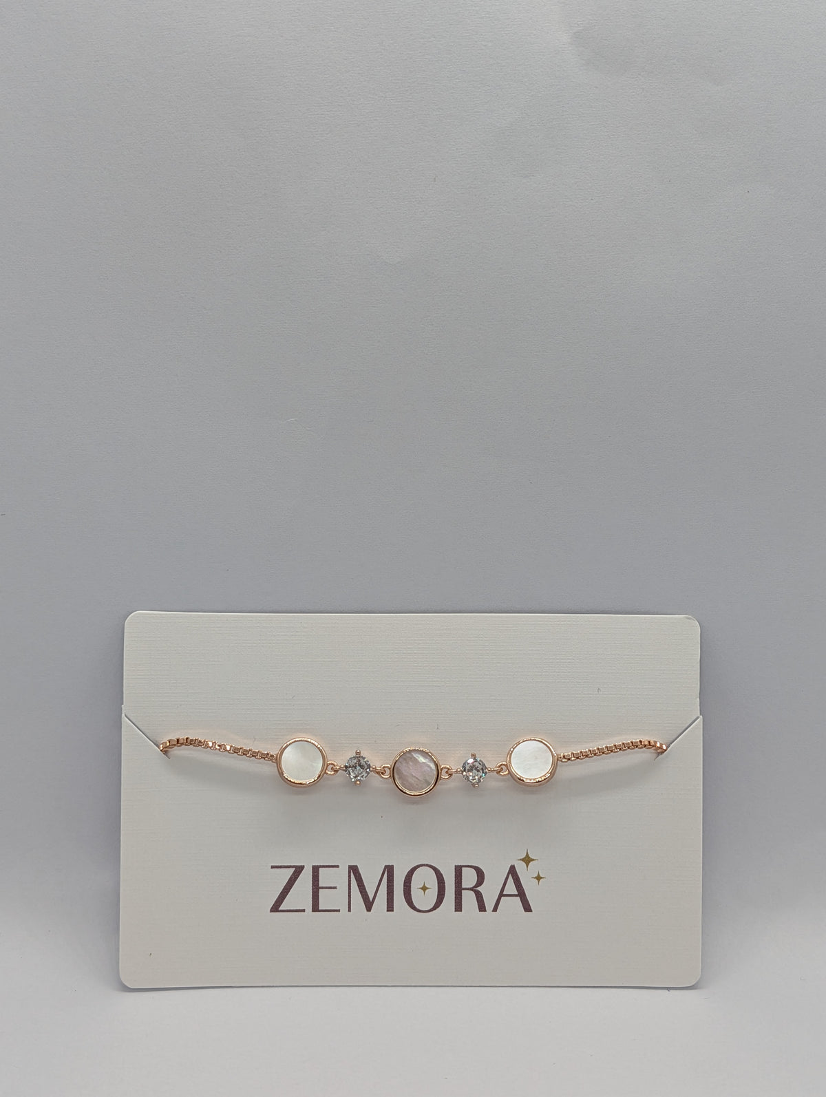 Rose gold luminous shell disc solitaire charm bracelet with bolo slider close-up