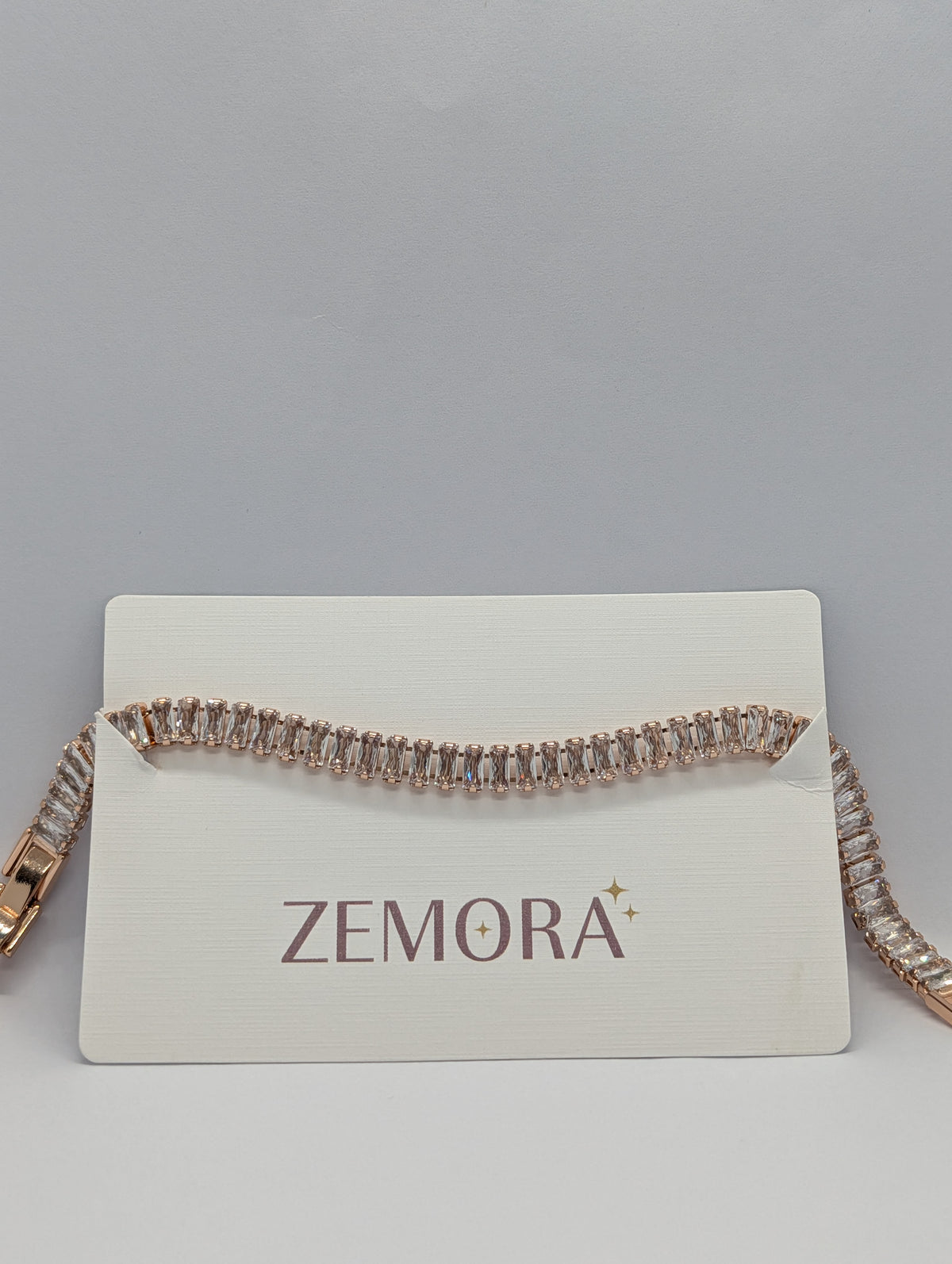 Rose gold baguette row tennis bracelet side angle showing channel-set baguette stones
