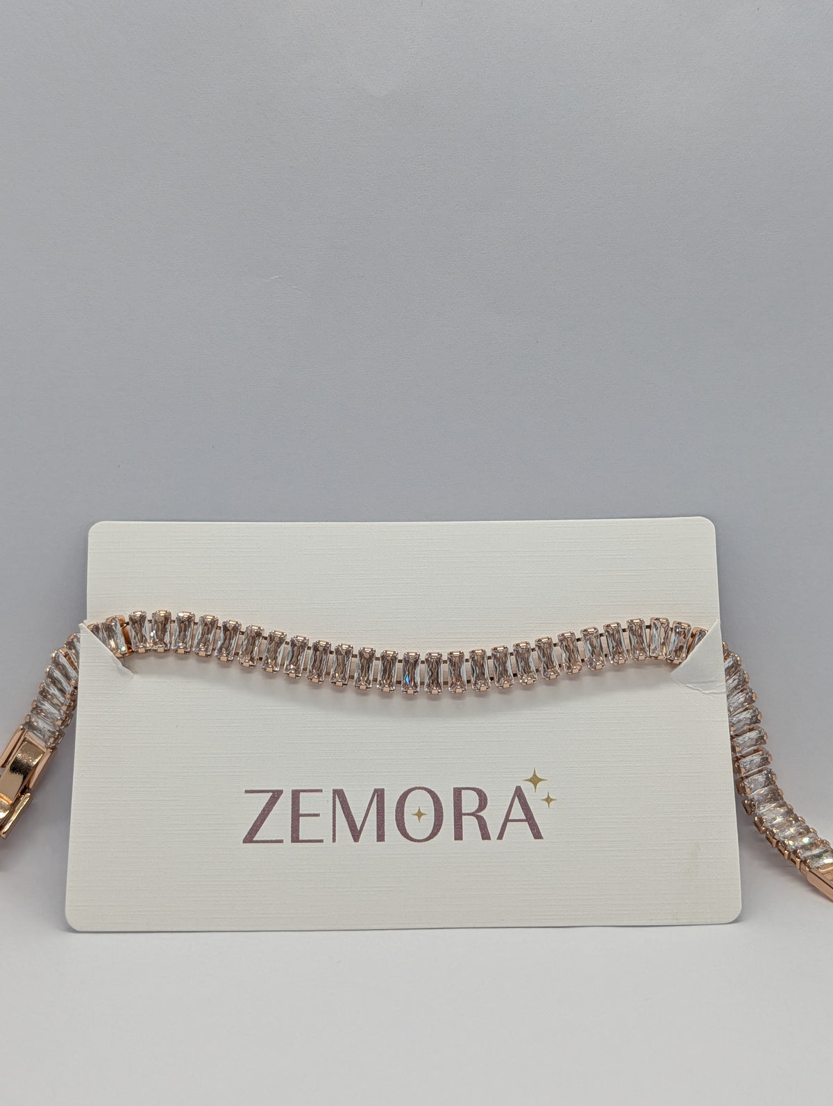 Rose gold baguette row tennis bracelet on Zemora jewellery card