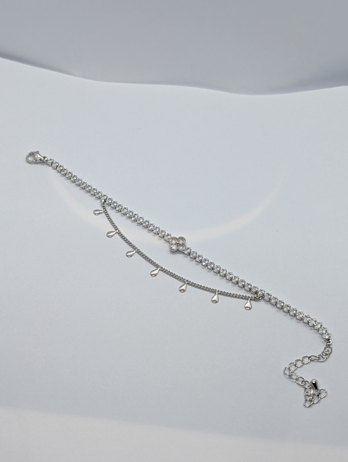 Silver double layer clover tennis and teardrop charm bracelet on Zemora jewellery card