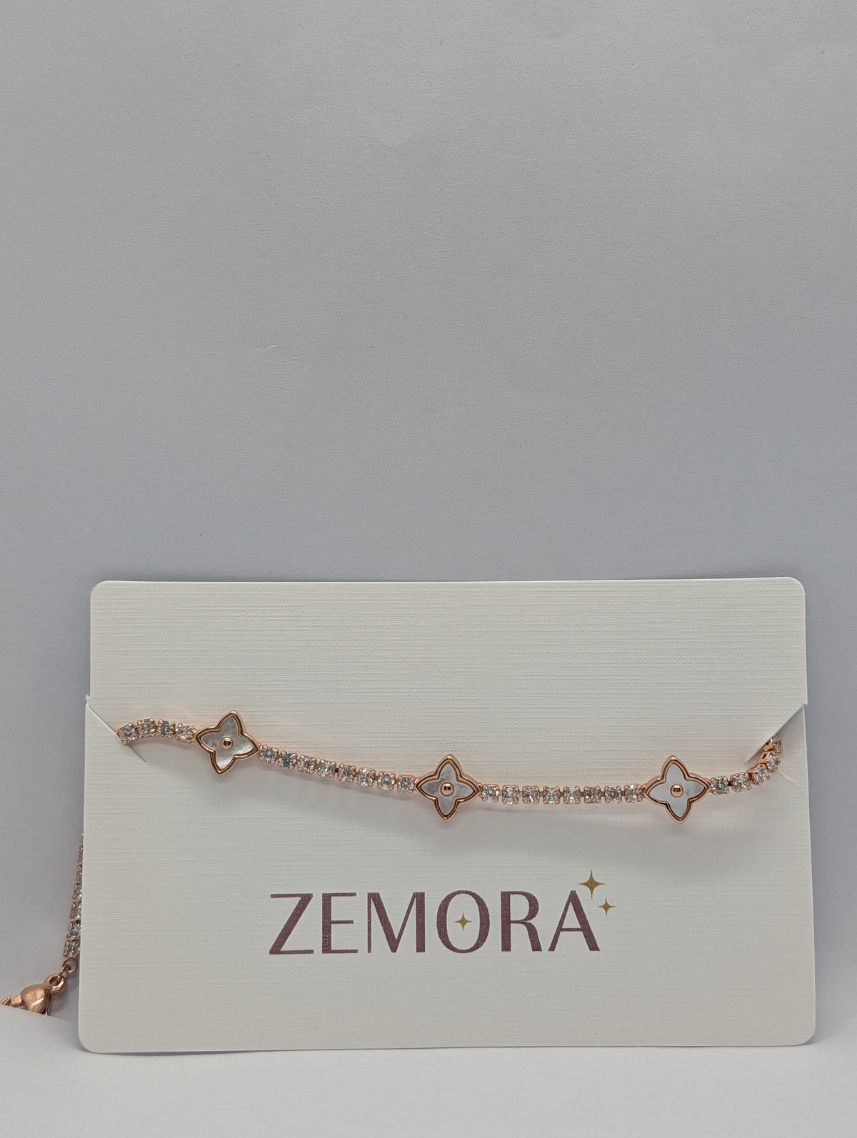 Rose gold pearl quatrefoil station CZ tennis bracelet on Zemora jewellery card