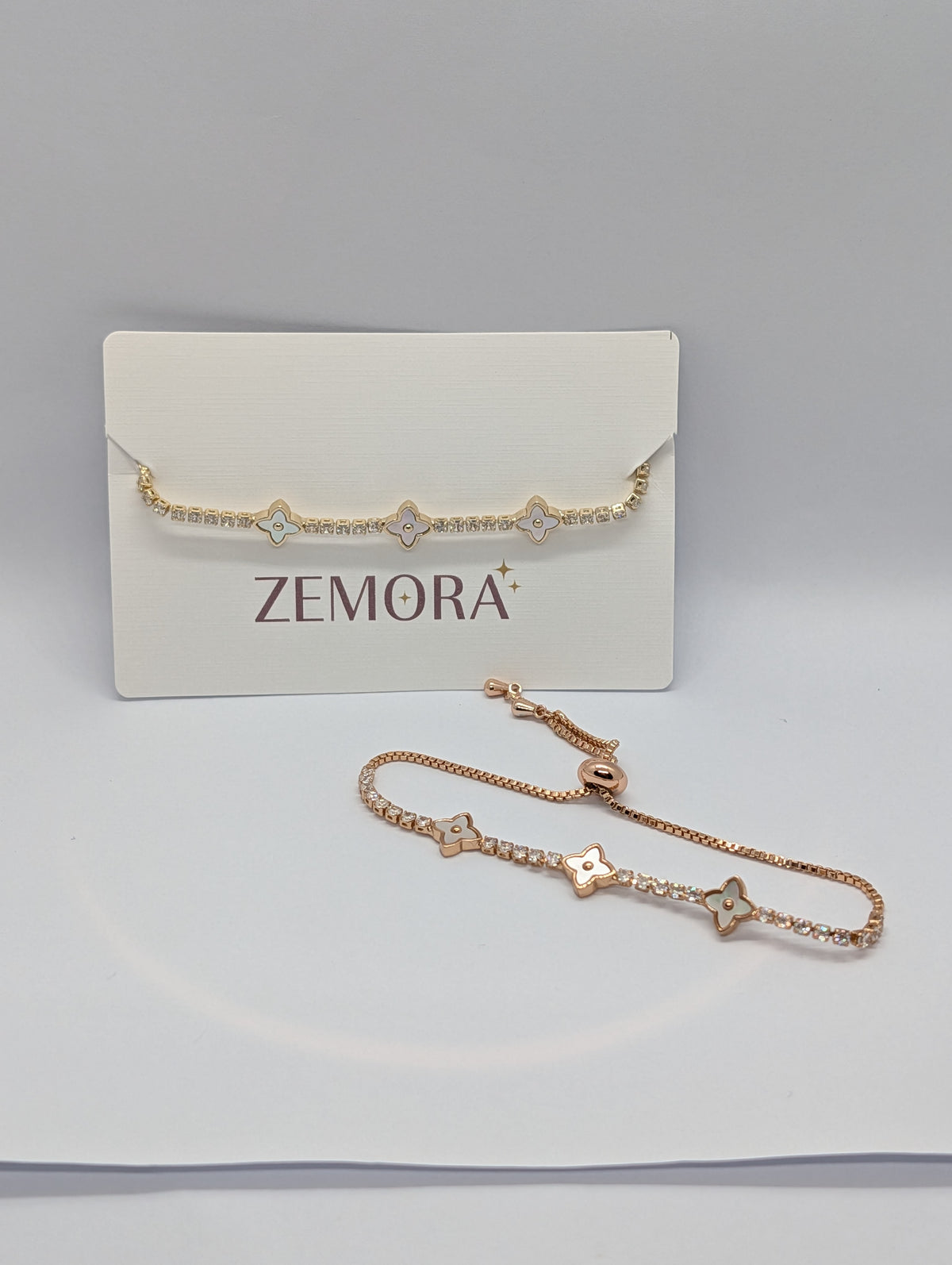 Silver pearl quatrefoil station CZ tennis bracelet on Zemora jewellery card