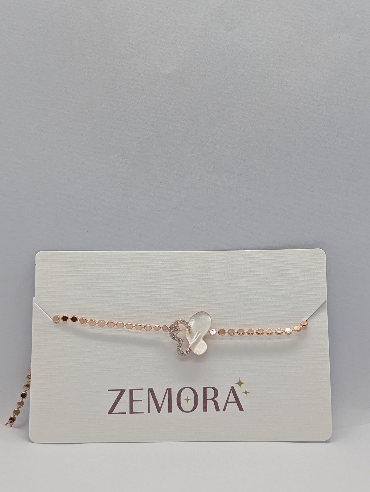Rose gold pearl and pavé half butterfly sequin chain bracelet on Zemora jewellery card