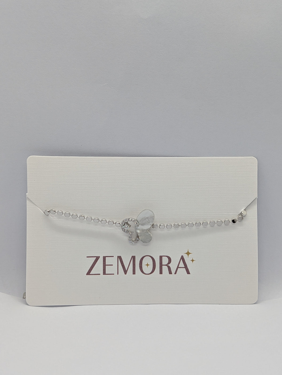 Silver pearl and pavé half butterfly sequin chain bracelet on Zemora jewellery card