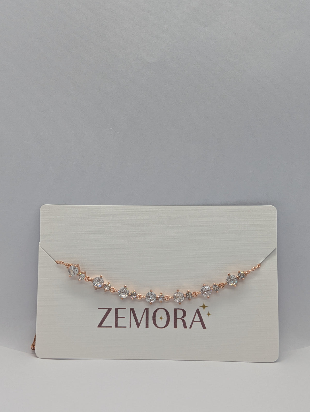 Yellow gold alternating marquise and round CZ station bracelet flat lay angle view