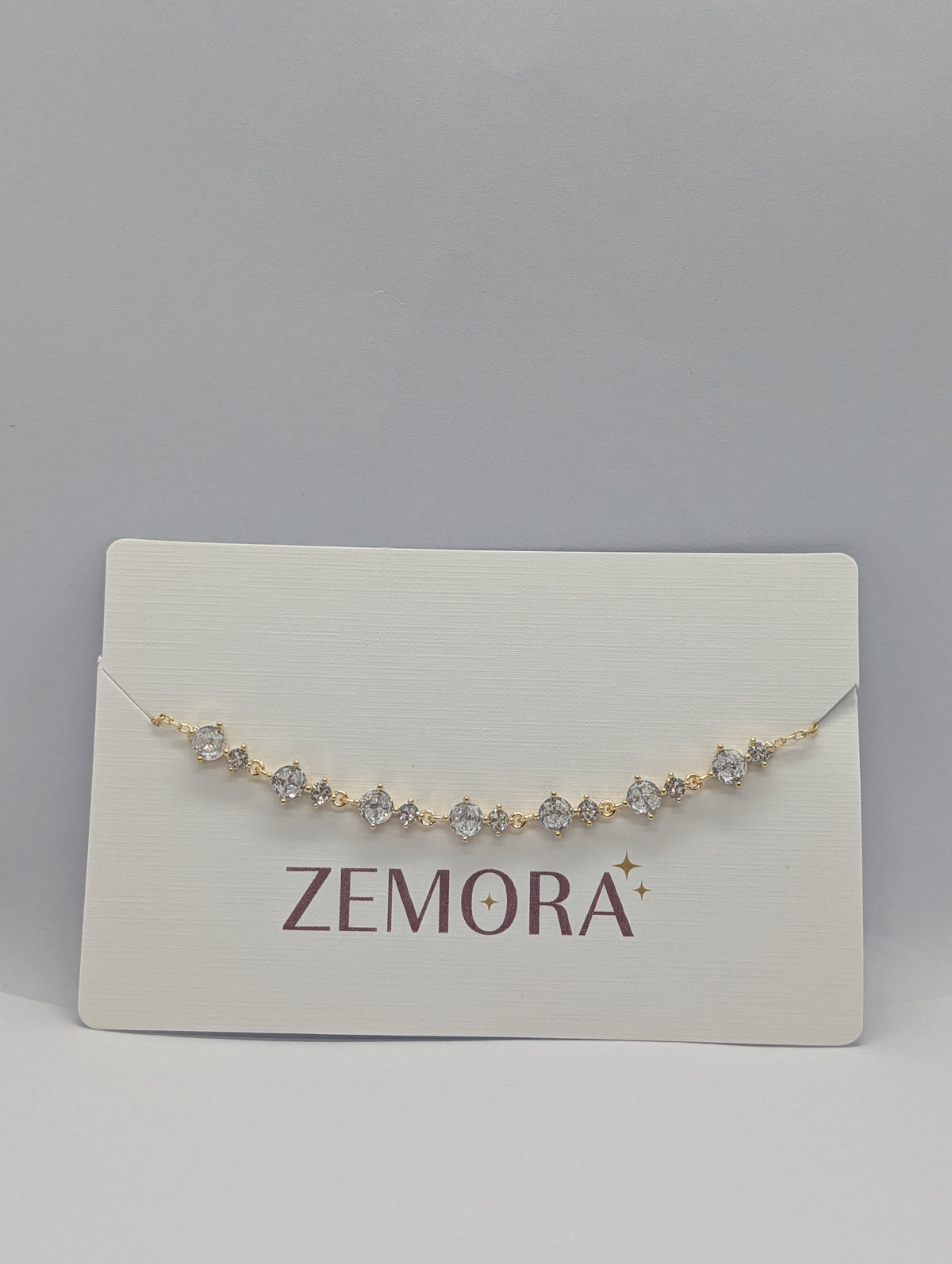 Rose gold alternating marquise and round CZ station chain bracelet flat lay