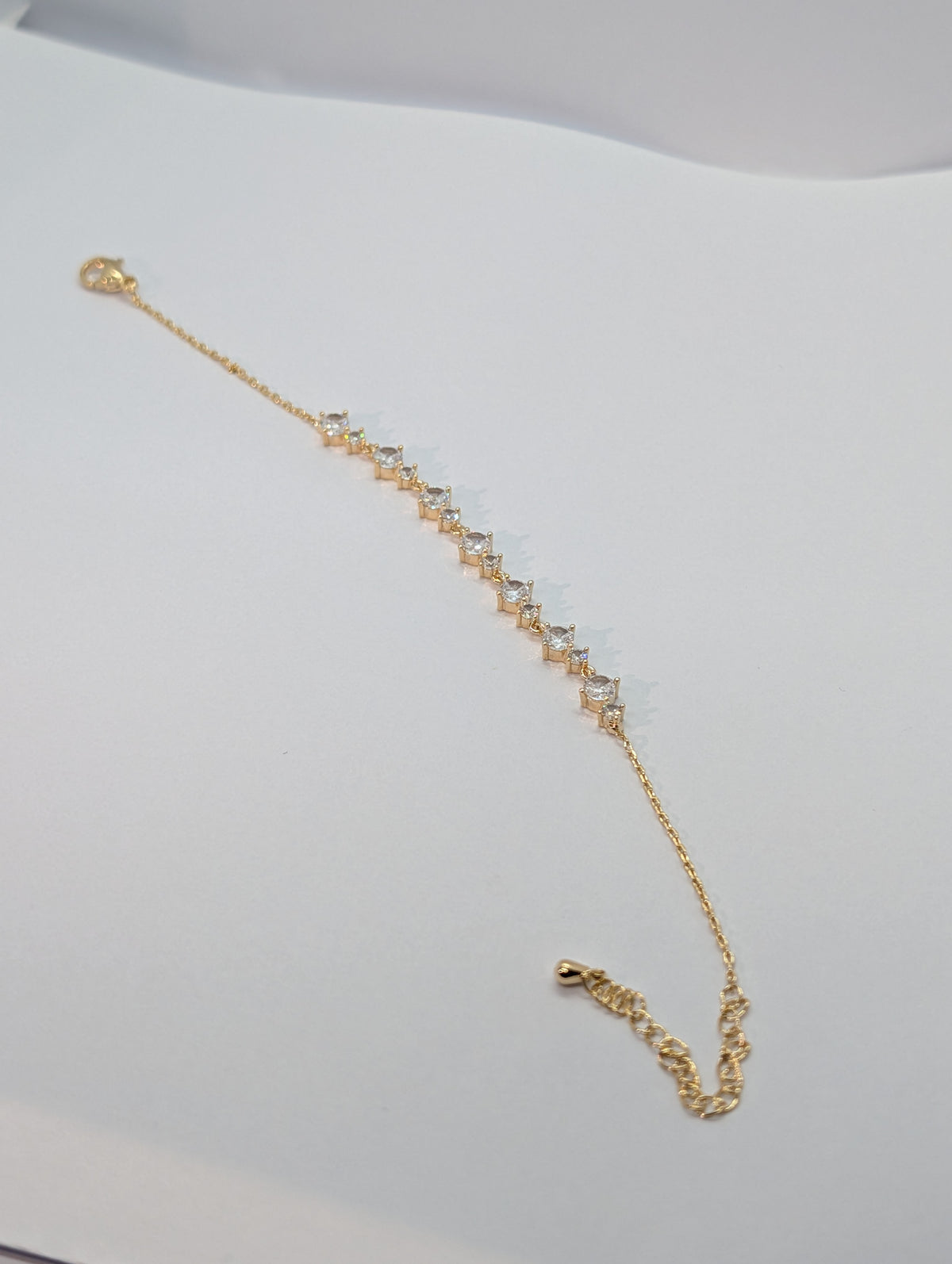 Silver alternating marquise and round CZ station chain bracelet flat lay