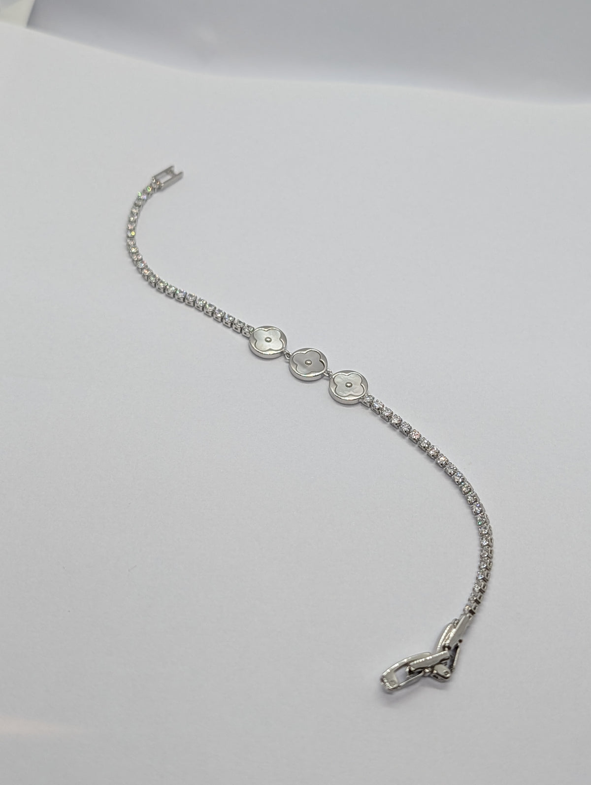 Rose gold dual-tone pearl clover trio CZ tennis bracelet on Zemora jewellery card