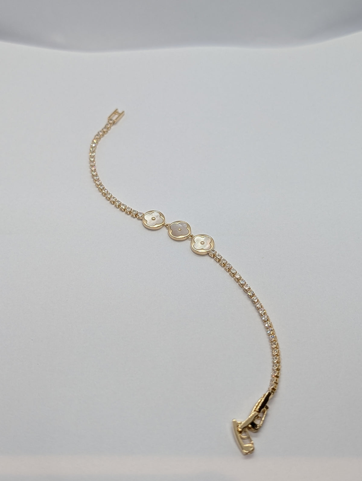 Yellow gold dual-tone pearl clover trio CZ tennis bracelet on Zemora jewellery card