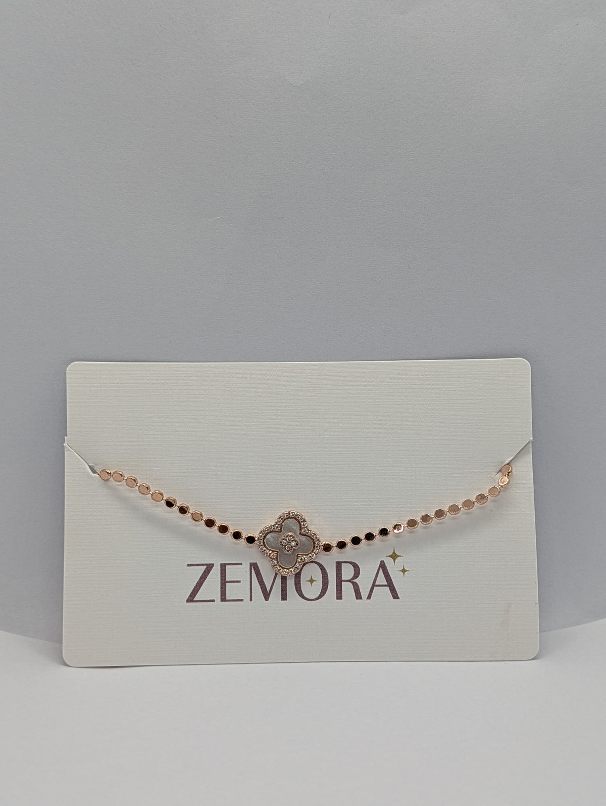 Silver pearl clover charm sequin chain bracelet flat lay showing full length and extender chain