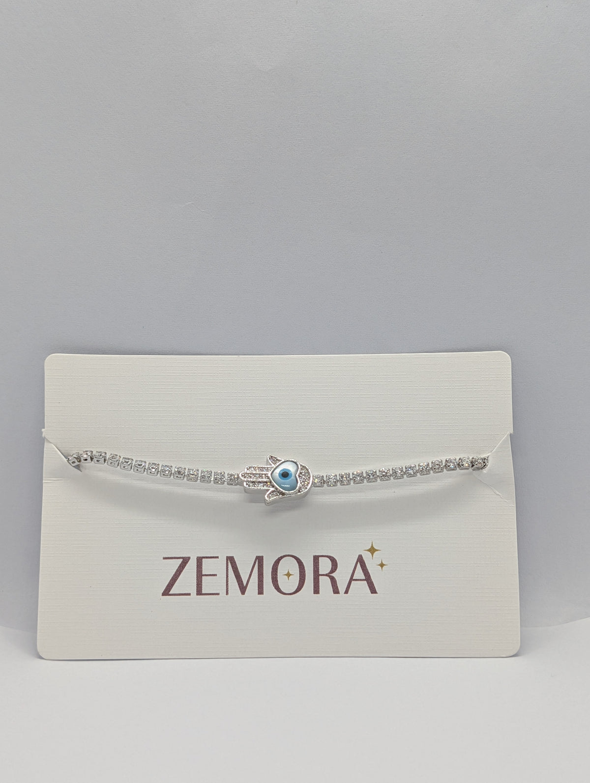 Silver evil eye Hamsa hand station CZ tennis bracelet on Zemora jewellery card