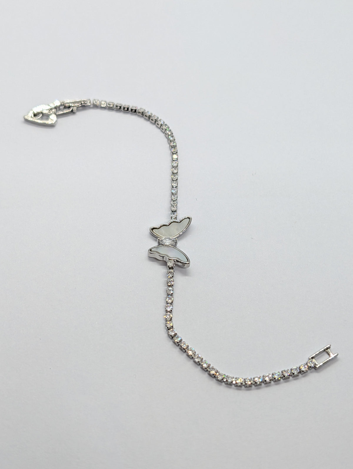Silver mother of pearl butterfly station CZ tennis bracelet on Zemora card