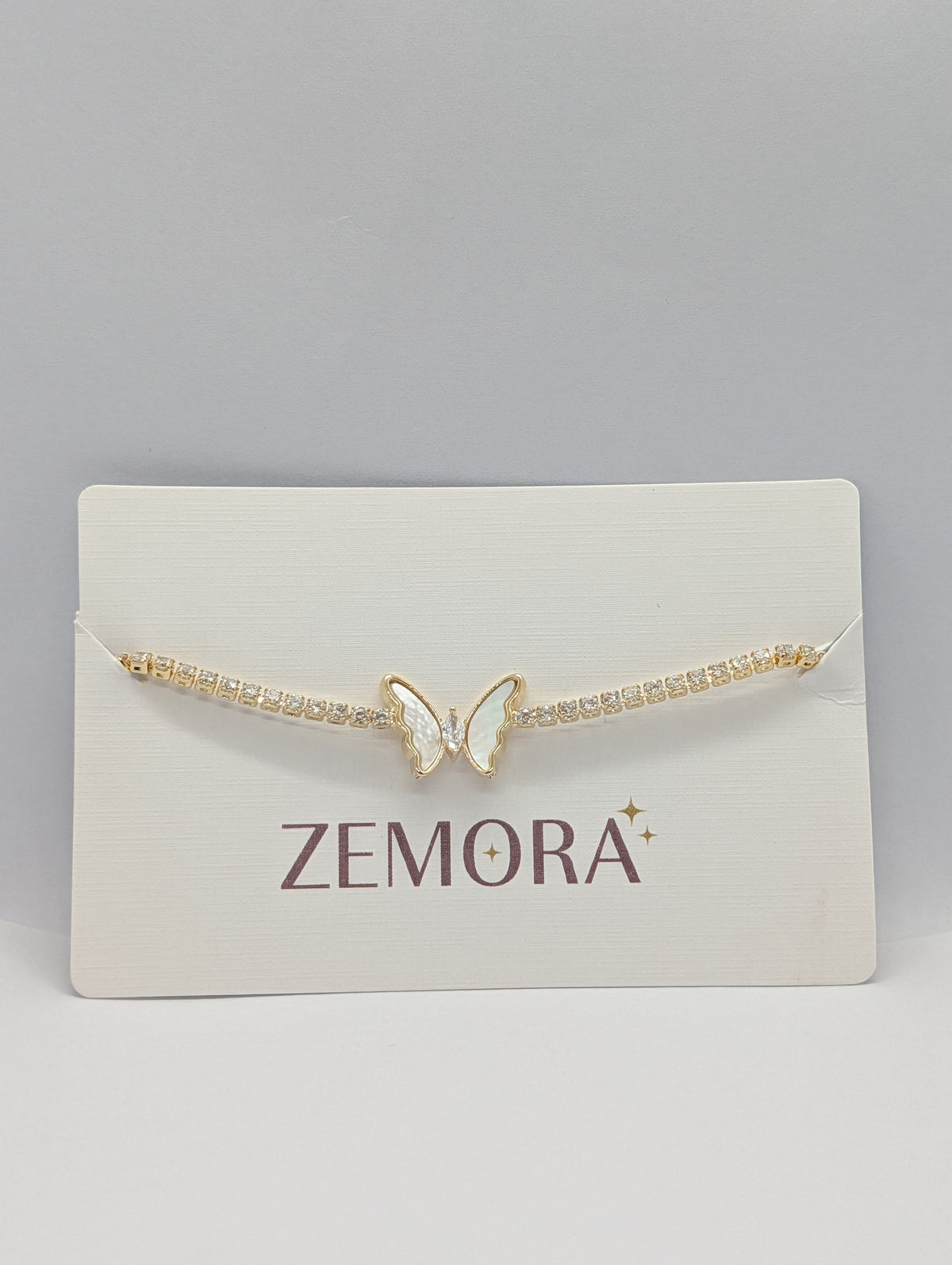 Rose gold mother of pearl butterfly station CZ tennis bracelet on Zemora card