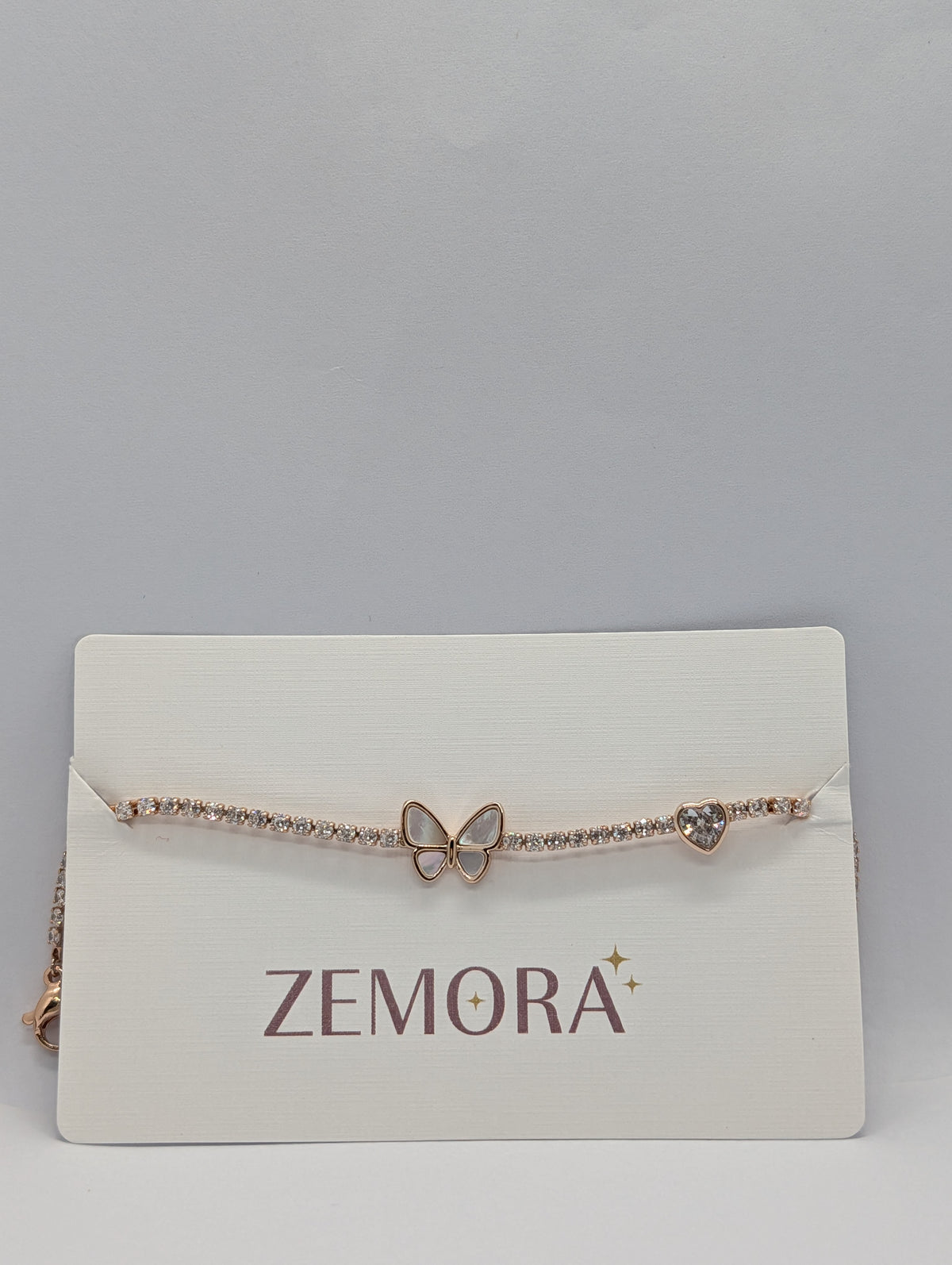 Rose gold butterfly heart duo station CZ tennis bracelet flat lay