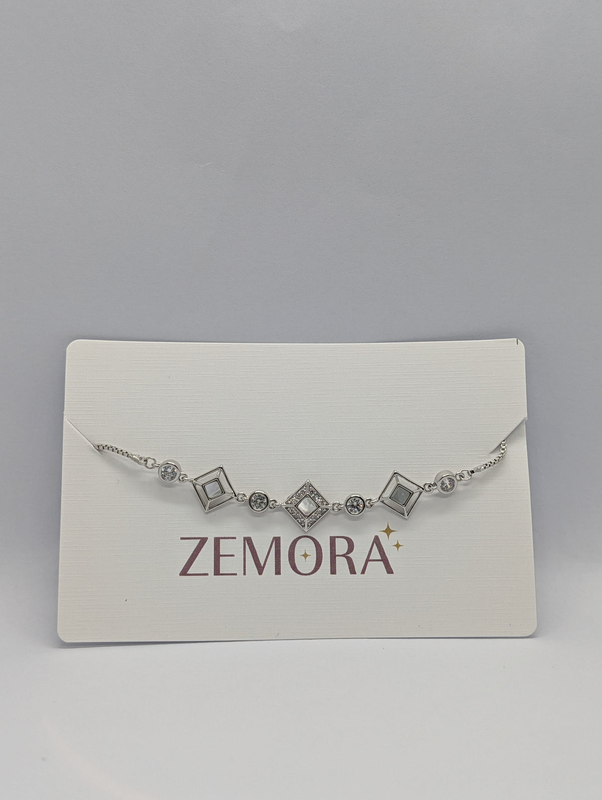 CZ Diamond Shape Station Bracelet - Silver tone on Zemora display card