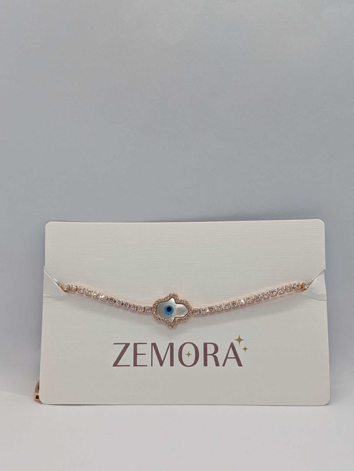 Hamsa Evil Eye CZ Tennis Bracelet - Rose Gold on Zemora display card