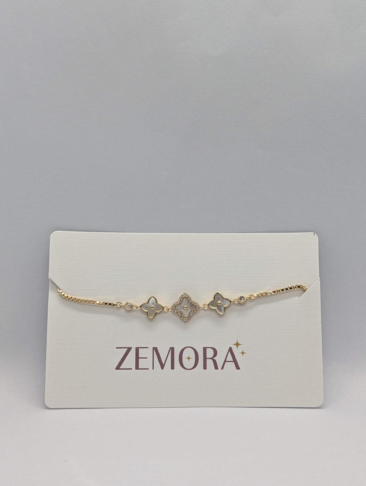 CZ Mother of Pearl Triple Flower Bracelet - Rose Gold tone angled view on Zemora card display
