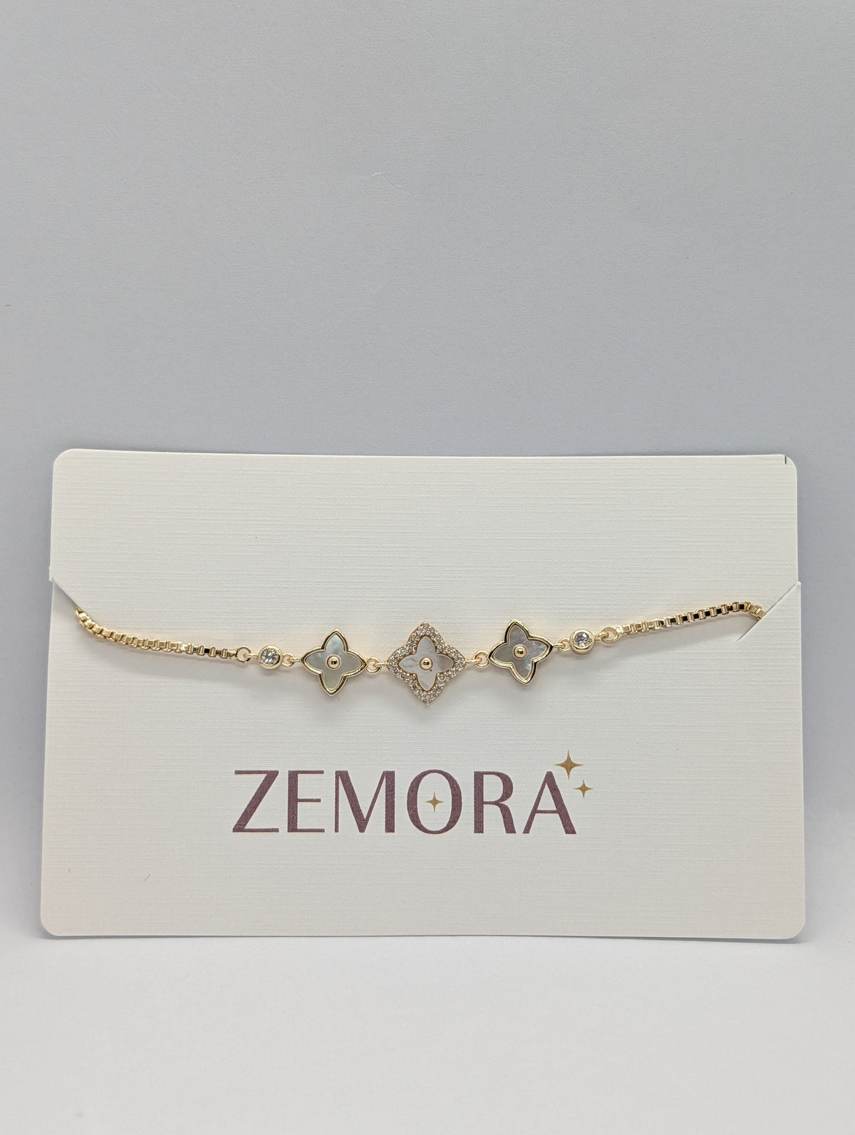CZ Mother of Pearl Triple Flower Bracelet - Rose Gold tone lower angle view on Zemora card display
