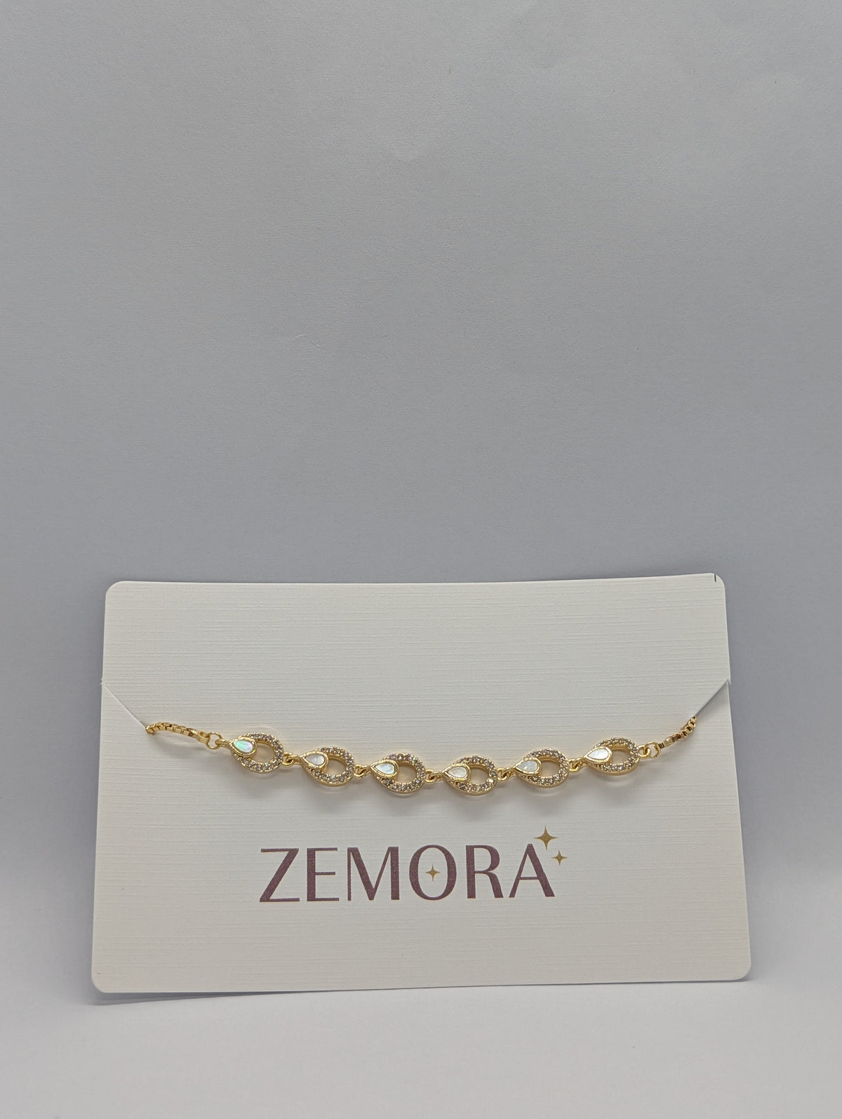 CZ Mother of Pearl Teardrop Link Bracelet - Gold tone on Zemora card display