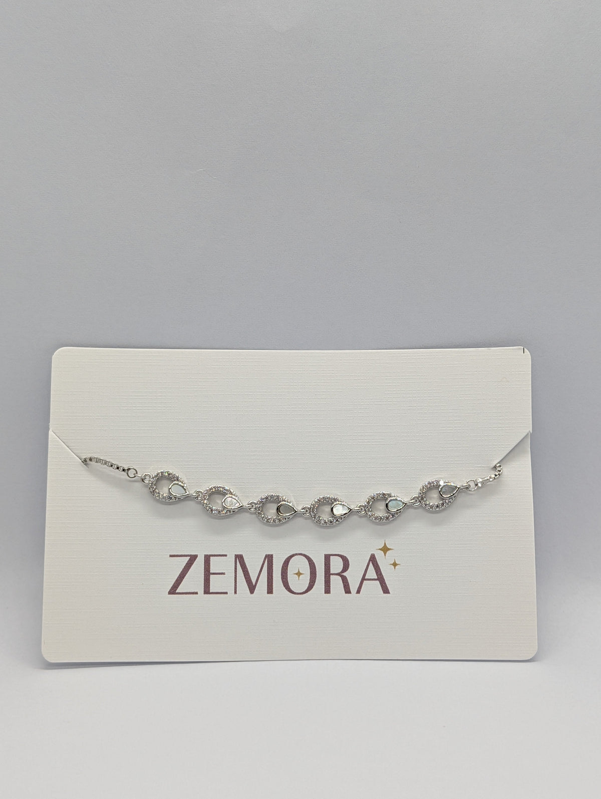CZ Mother of Pearl Teardrop Link Bracelet - Silver tone on Zemora card display