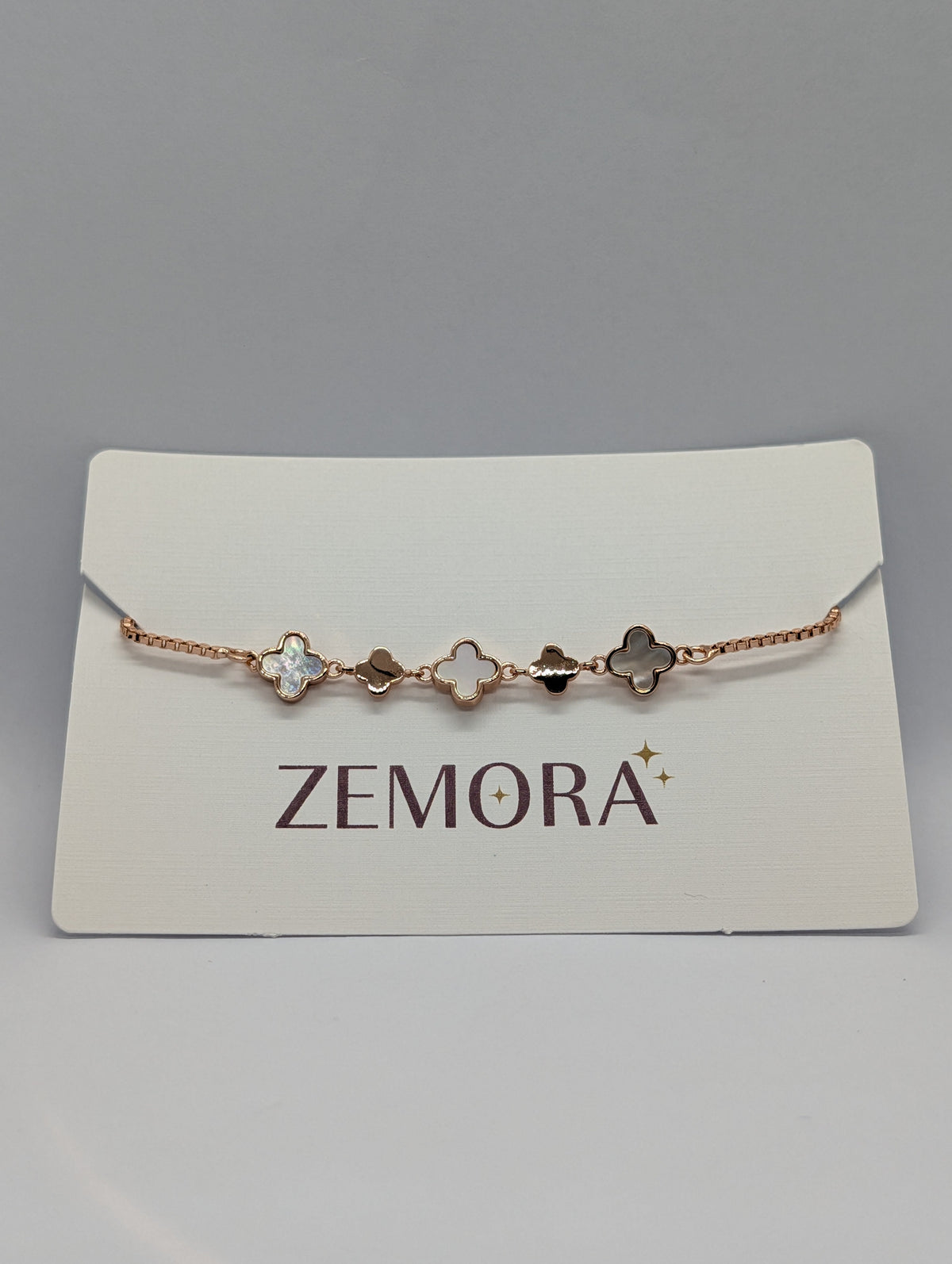 Mother of Pearl Onyx Clover Station Bracelet - Gold tone on Zemora card display