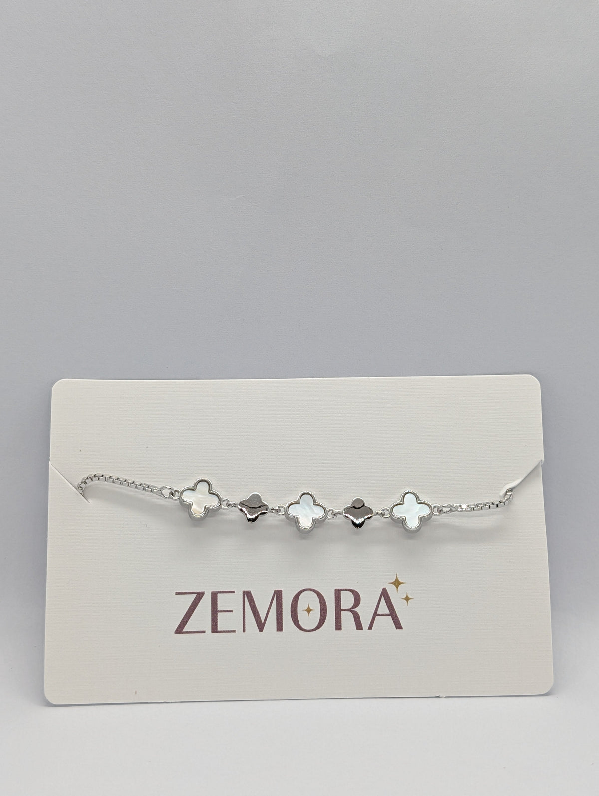 Mother of Pearl Onyx Clover Station Bracelet - Rose Gold tone on Zemora card with bolo closure detail