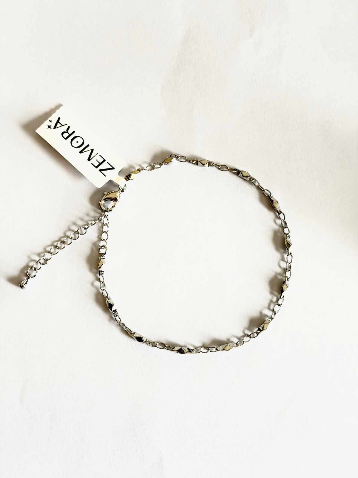 Diamond-Cut Figaro Chain Anklet - Silver tone full view with Zemora tag