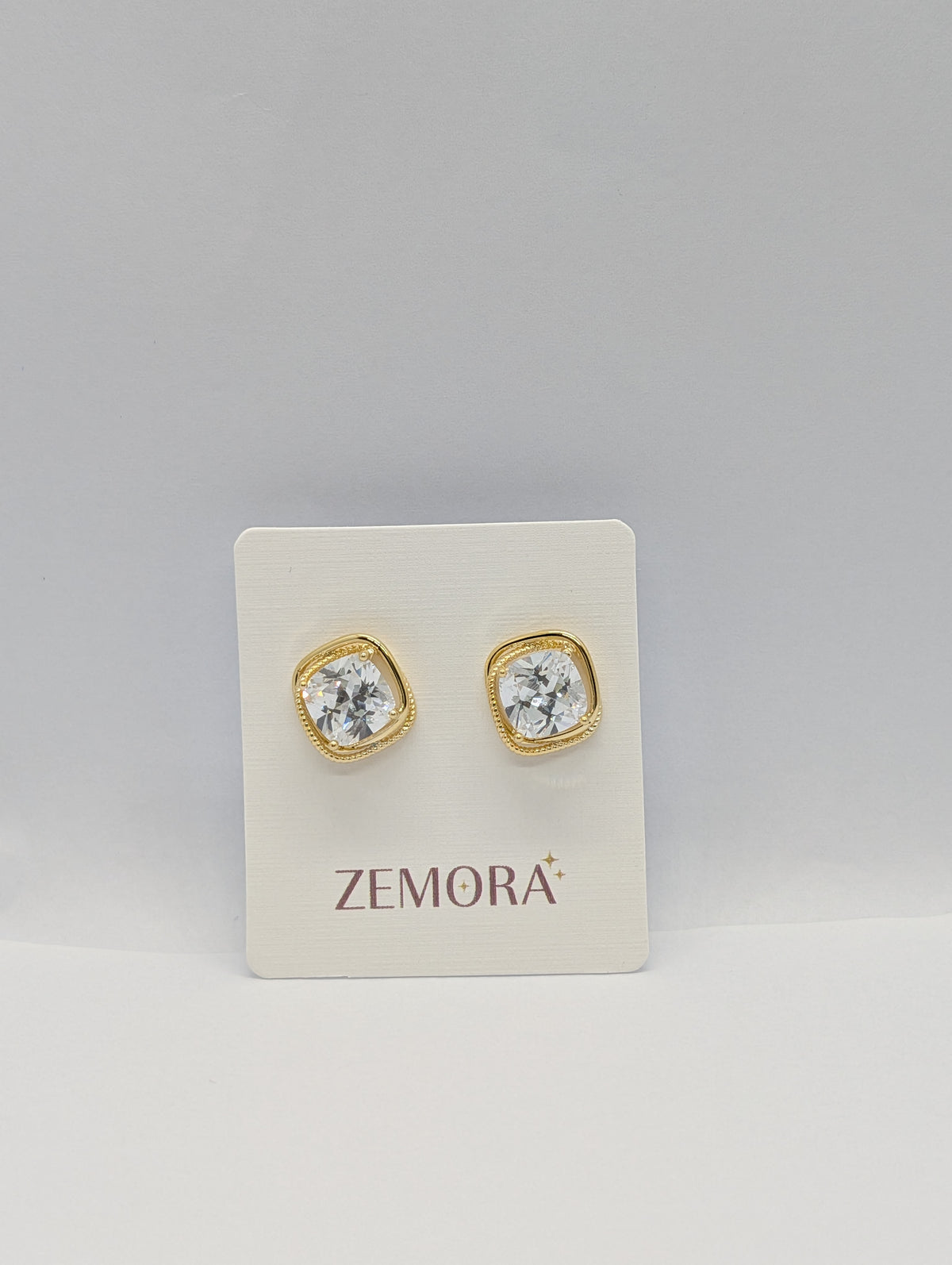 Cushion-Cut CZ Milgrain Stud Earrings - Gold tone on Zemora display card