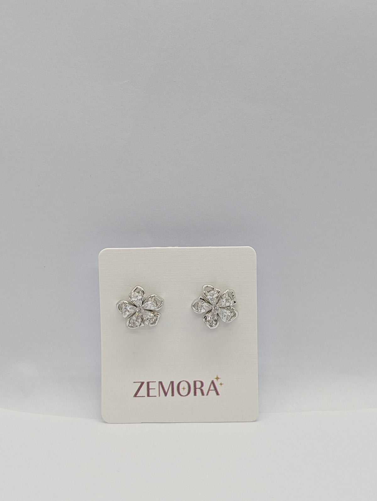 CZ Petal Flower Stud Earrings - Silver tone on Zemora display card