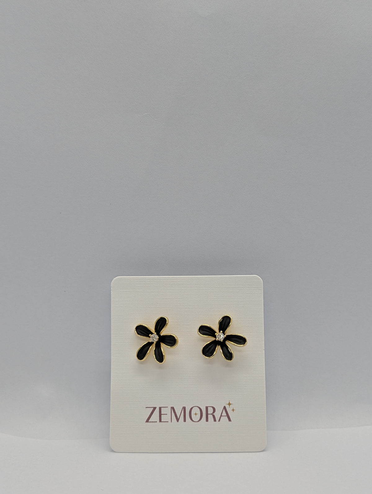 Black Enamel Daisy CZ Centre Stud Earrings - Gold tone on Zemora display card