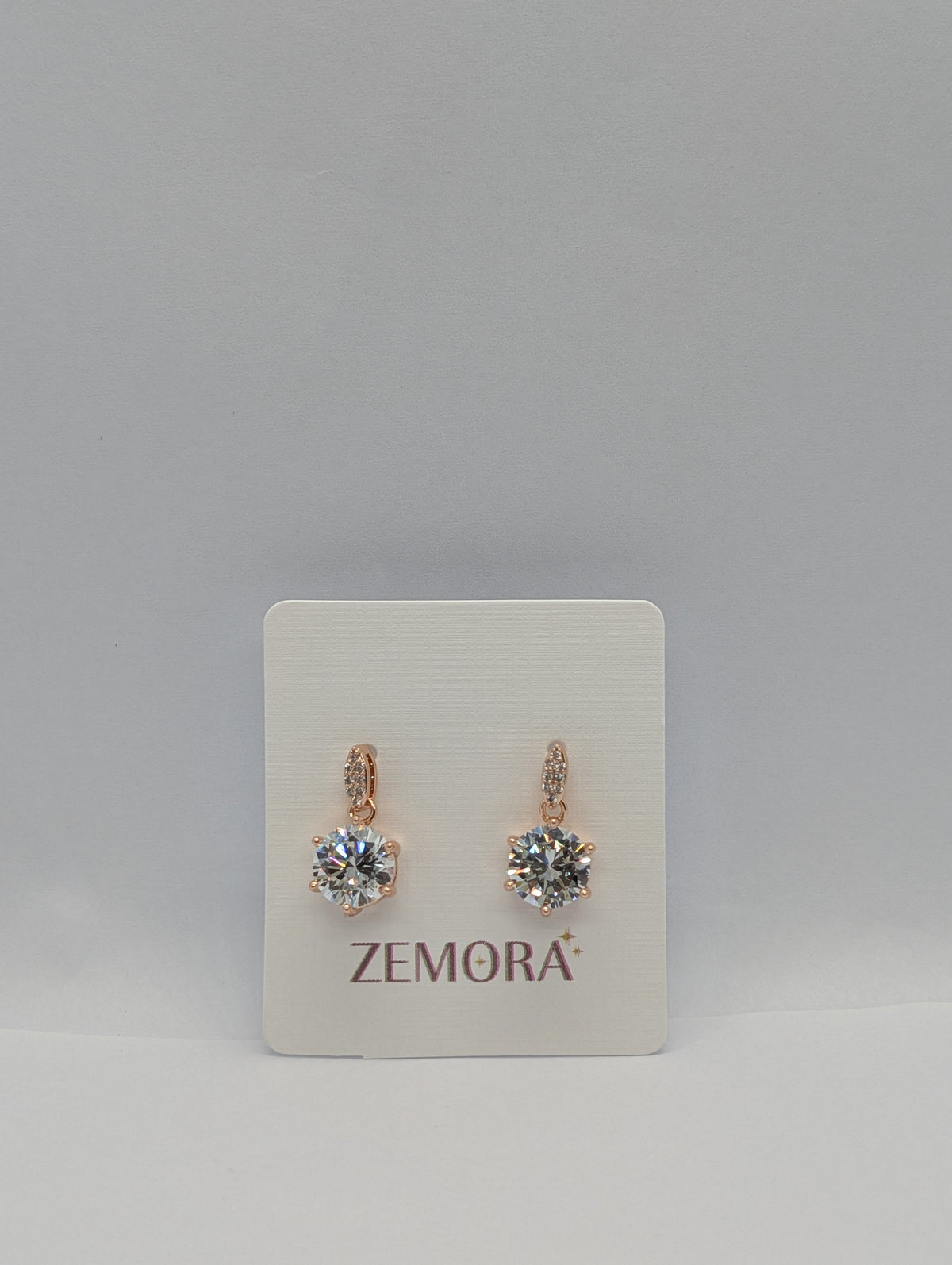 CZ Solitaire Drop Huggie Earrings - Rose Gold tone pair on Zemora card display
