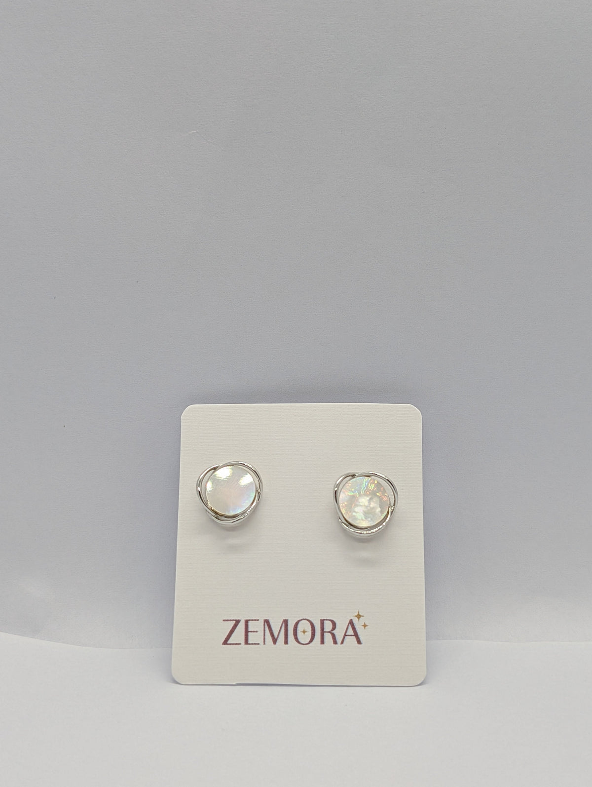 Mother of Pearl Wire Wrap Circle Stud Earrings - Silver tone pair on Zemora card display