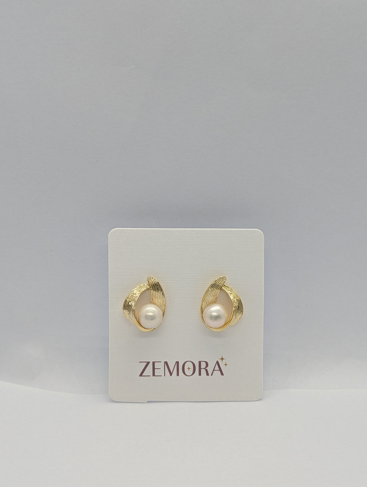 Pearl Ribbed Wire Wrap Stud Earrings - Gold tone pair on Zemora card display