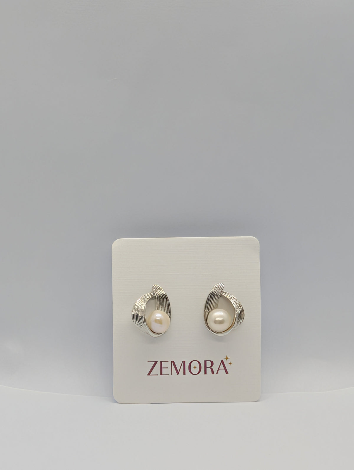 Pearl Ribbed Wire Wrap Stud Earrings - Silver tone pair on Zemora card display