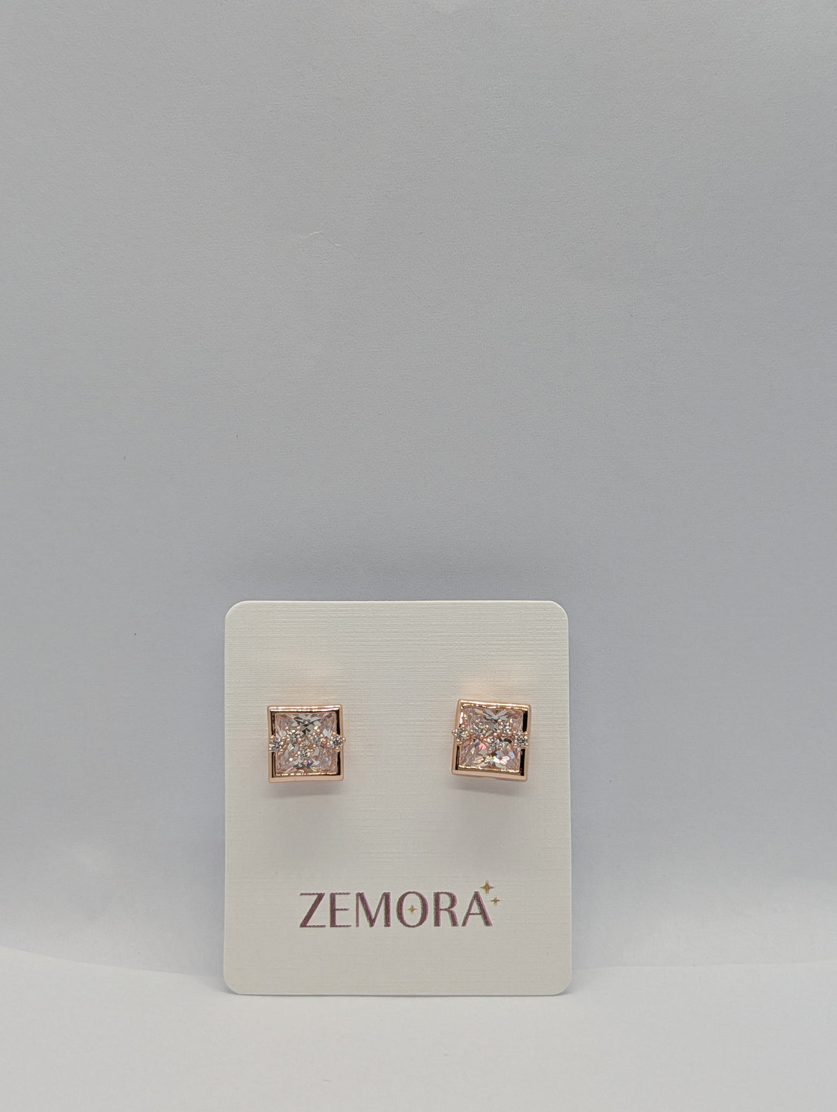Princess Cut CZ Square Bezel Stud Earrings - Rose Gold tone pair on Zemora card display