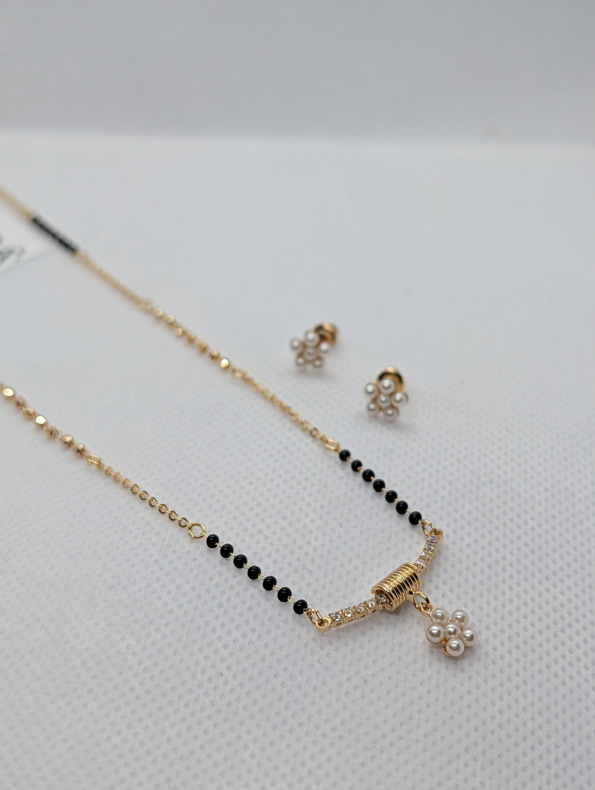 CZ Bar Pearl Flower Cluster Mangalsutra Set - Gold tone pendant and earrings close up