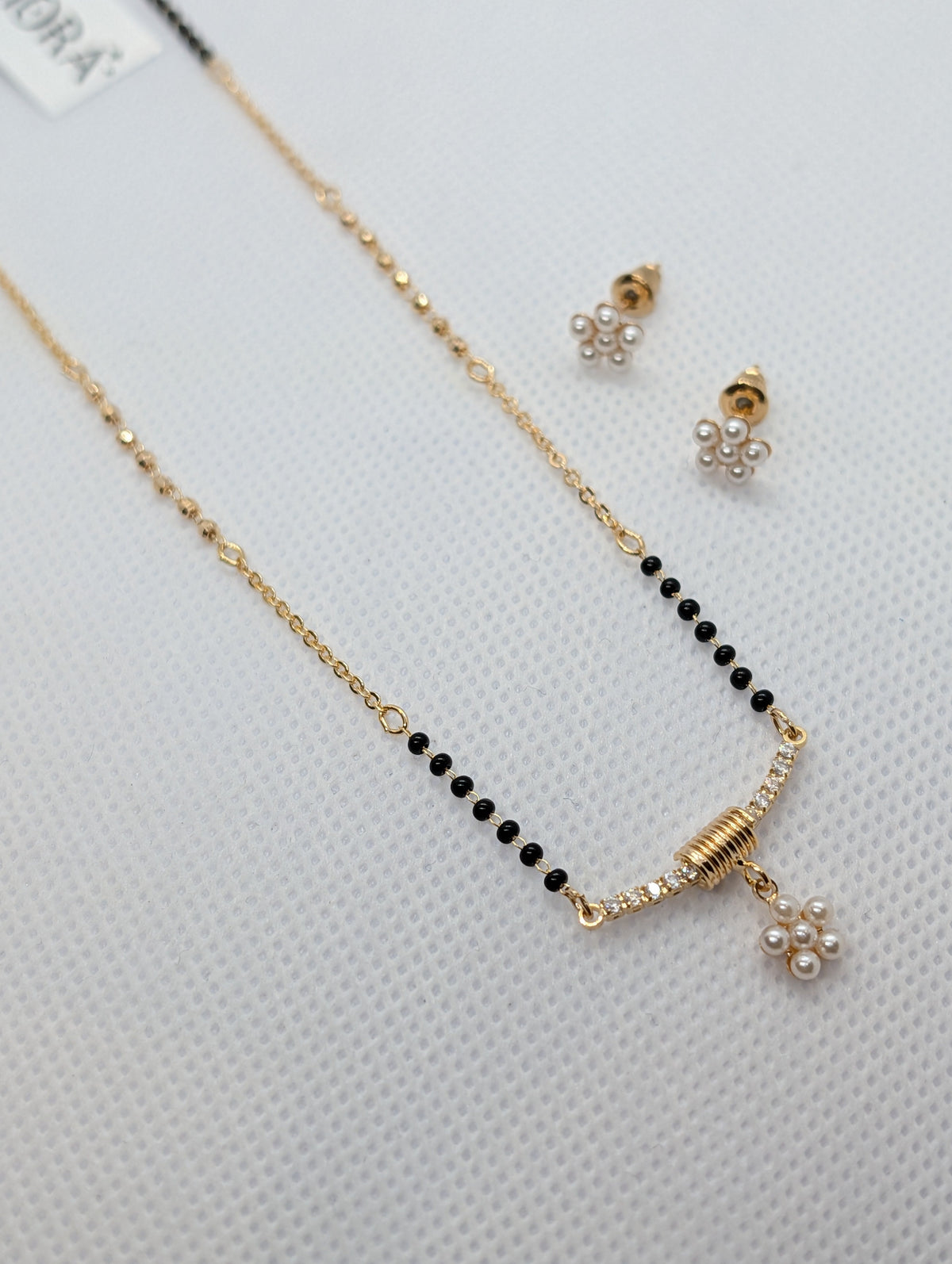CZ Bar Pearl Flower Cluster Mangalsutra Set - Gold tone full view flat lay